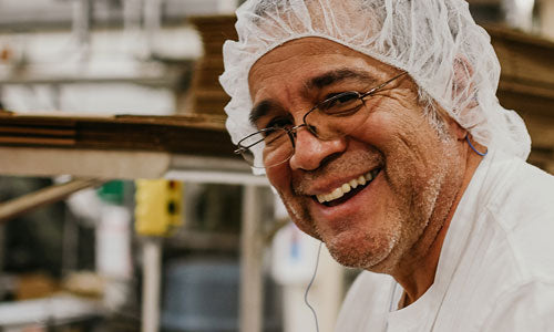 man with hair net smiling